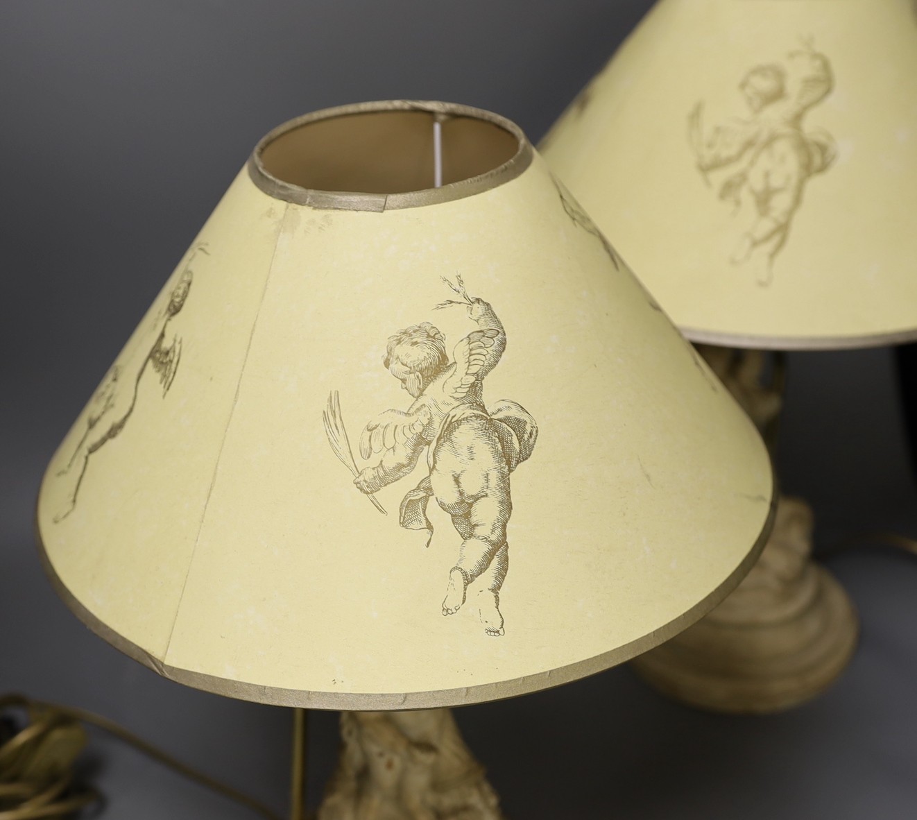 A pair painted composition cherub lamps on plinth base, altogether 43cm tall